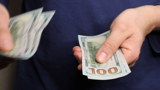 Mains caucasiennes comptant les billets en dollars sur fond bleu darl. Épargne, finances, économie et concept d'habitation
  - Séquence, vidéo