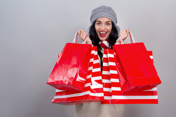 Happy young woman holding shopping bags - Foto, Bild