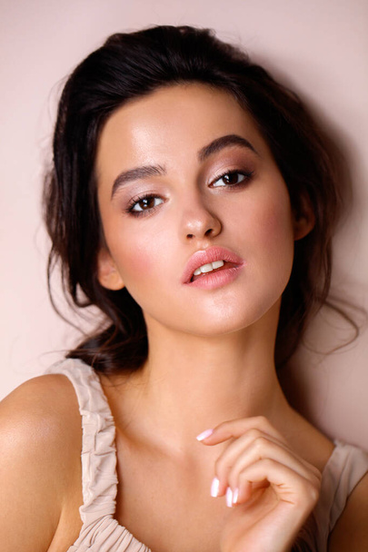  portrait of a model with professional makeup on a beige background - Foto, Imagem