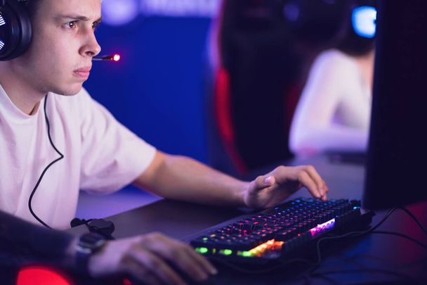 Streamer man professional gamer playing online games computer with headphones - Fotografie, Obrázek
