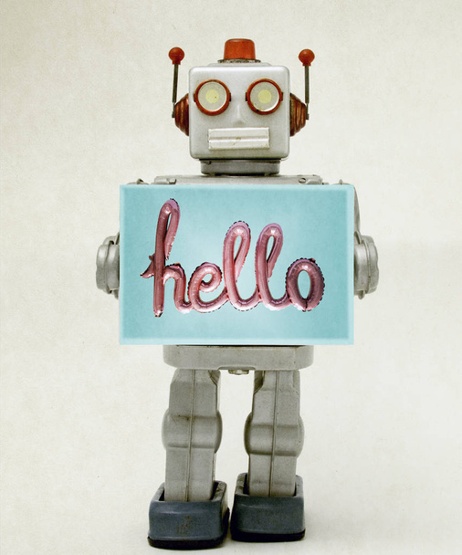 robot juguete sosteniendo un hola signo
   - Foto, Imagen