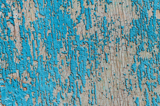 Old and peeling paint Over time, the blue paint peeled off from the old boards and the wood texture cracked. Vintage Abstract Grunge Background - Fotoğraf, Görsel