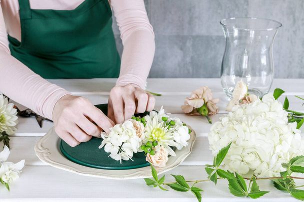 Woman shows how to make wedding table decoration with wreath and - Fotoğraf, Görsel