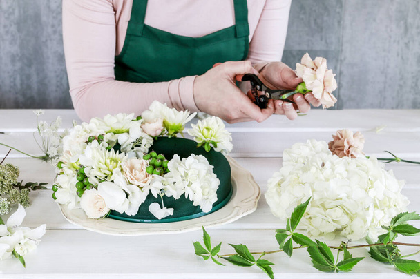 Woman shows how to make wedding table decoration with wreath and - Foto, imagen