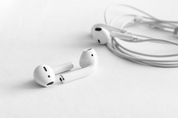 Comparaison sans fil des écouteurs blancs avec des écouteurs filaires, espace de copie
 - Photo, image