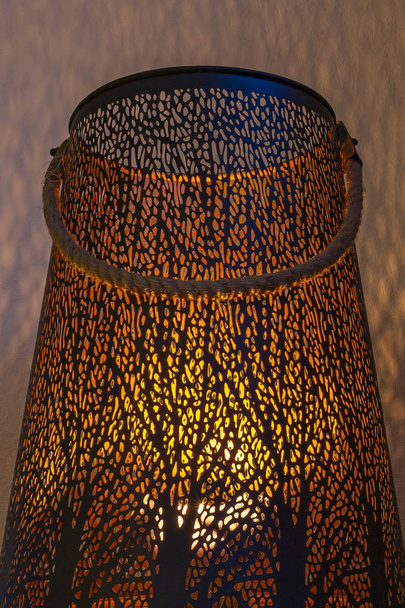 The candlelight gives nice shades on the wall by the patterns in the side of the candle holder, Zoetermeer, Netherlands - Photo, Image