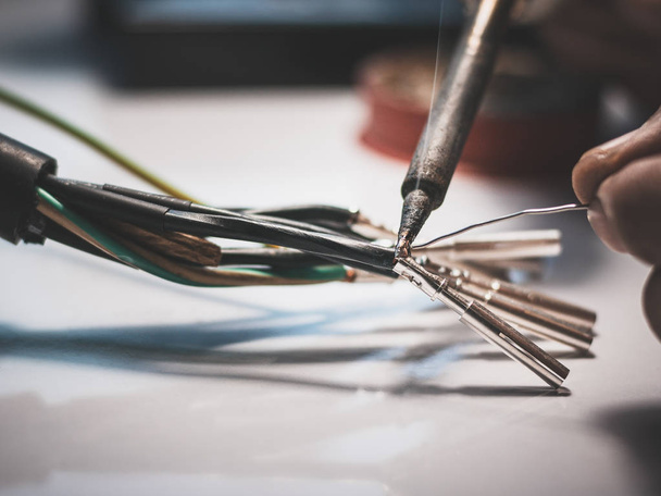 Electricians are using a soldering iron to connect the wires to  - Photo, Image