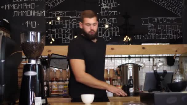 A cheerful man dances and makes coffee baristo. - Footage, Video