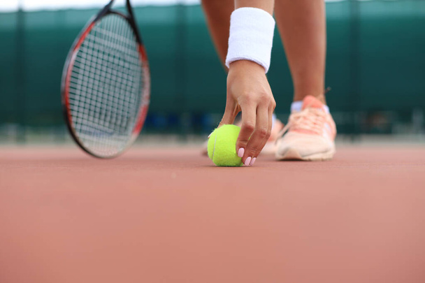 Tennis racket and the ball on tennis court. - Fotó, kép