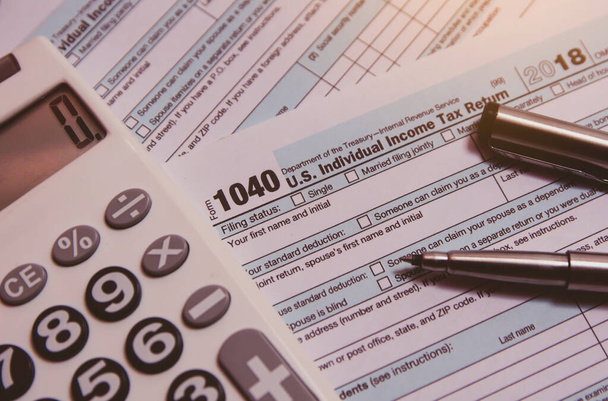 Tax season. calculator, pen on 1040 tax form background - Photo, image
