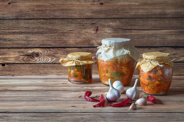 Various kimchi in glass jars on a wooden table. - Photo, Image