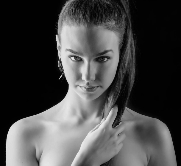 Black ans white portrait of a beautiful young woman. Selective soft focus on eyes. - Fotó, kép