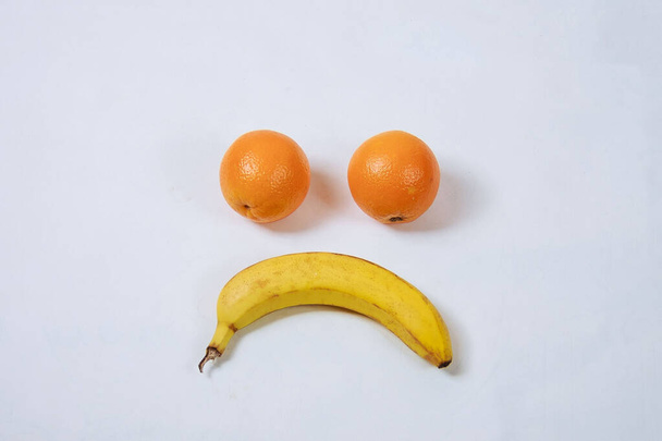tomato and banana forming a smiley face isolated on white - Valokuva, kuva