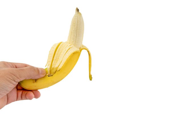 mano sosteniendo plátano aislado sobre fondo blanco
 - Foto, imagen