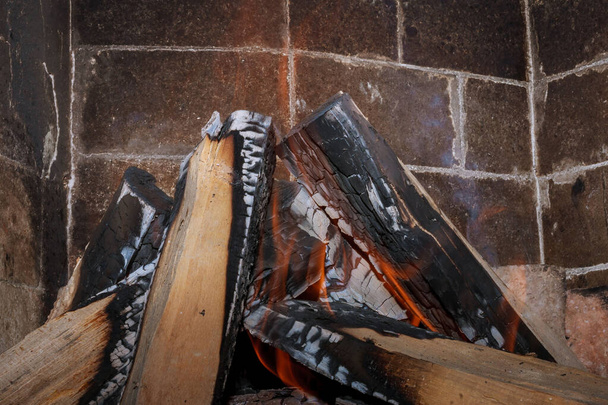 Burning firewood in the fireplace close up - Photo, Image