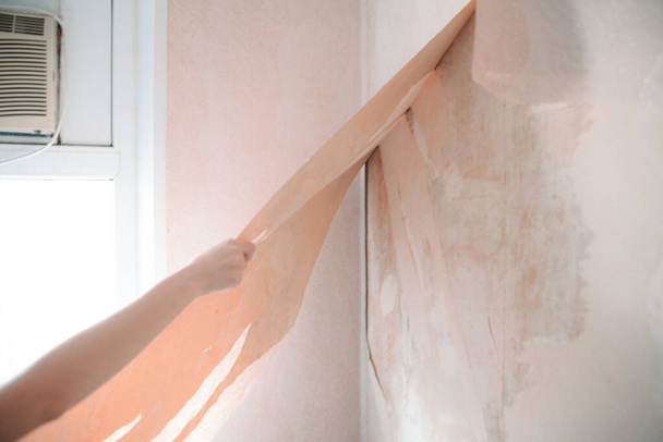 Home renovation, room wall repairing, woman removing old wallpaper - Φωτογραφία, εικόνα
