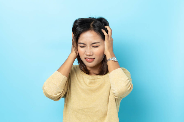 asian young woman having headache on white background - Photo, image