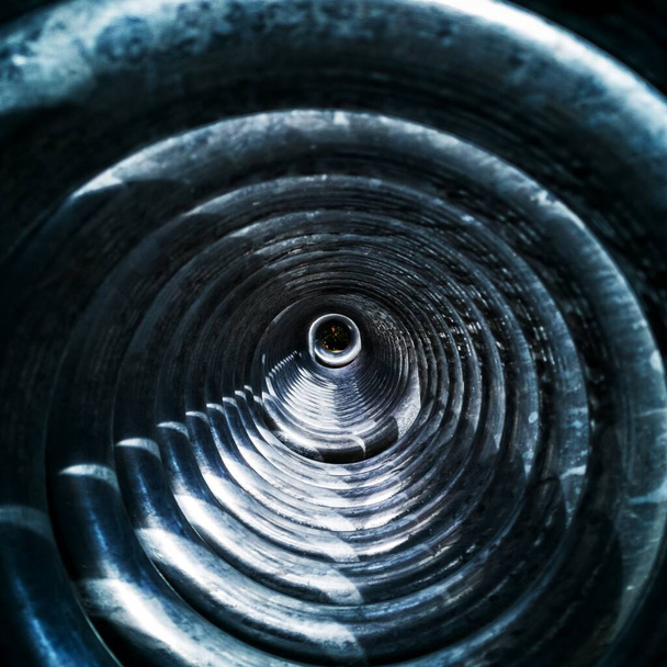 Closeup shot of a grey worn-out coil's inside. Perfect for a background. - Foto, Imagen