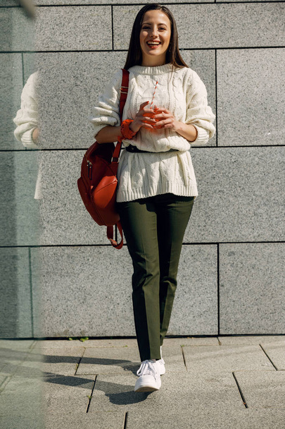 Cheerful young female walking with lemonade in hands - Φωτογραφία, εικόνα
