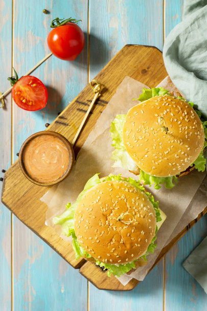 American snack Street food. Fast food. Homemade hamburger on woo - Fotó, kép