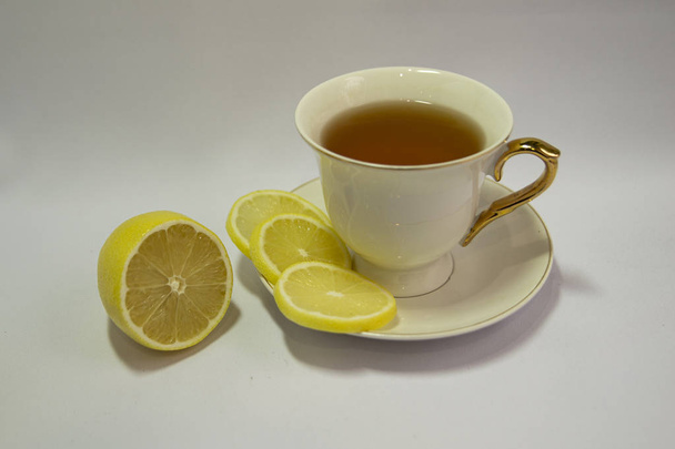 Porcelain white tea Cup isolated on white background. Limon. Tea party. Prevention of colds. - Foto, imagen