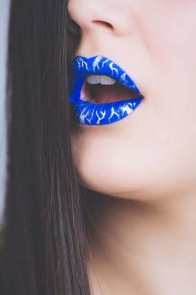 Vertical closeup shot of a long-haired female wearing blue lipstick - 写真・画像
