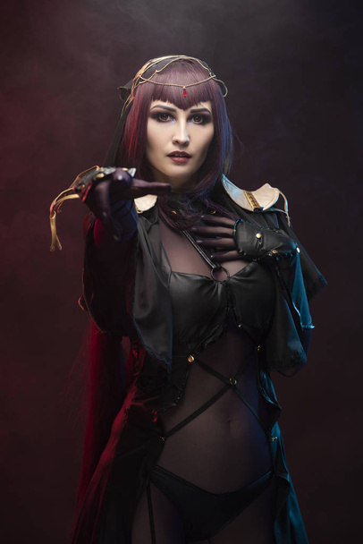 A beautiful leggy busty cosplay girl wearing an erotic leather c - Фото, изображение