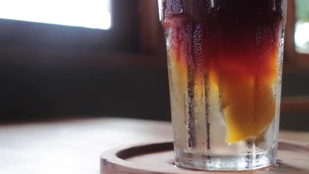 Iced glass of peach soda drink up close, stock footage - Footage, Video