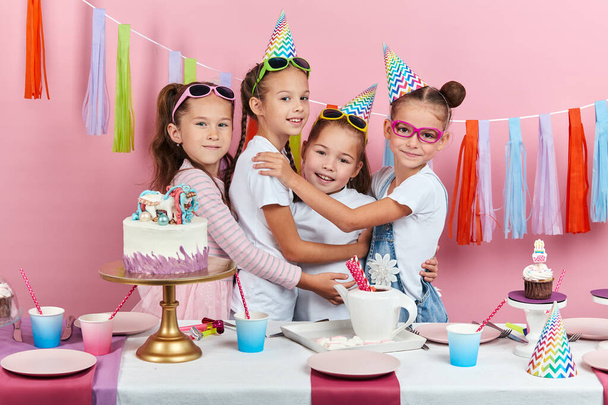 little awesome girls congratulating their best friend with birthday - Фото, изображение