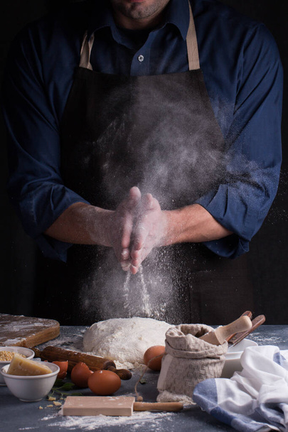 Baker prepares the dough on table. Homemade pastry. - Photo, image