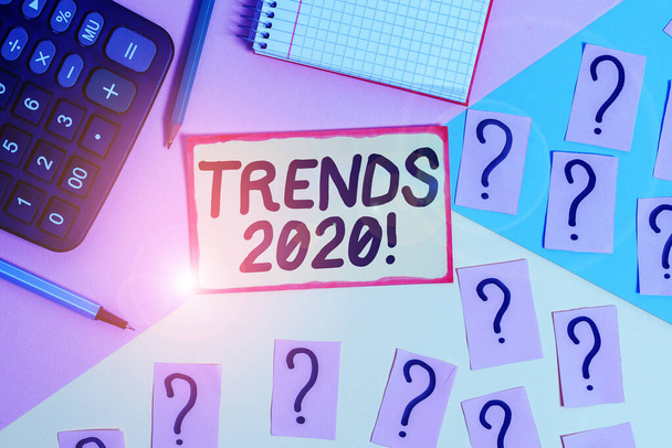 Text sign showing Trends 2020. Conceptual photo general direction in which something is developing or changing Mathematics stuff and writing equipment above pastel colours background. - Foto, Bild