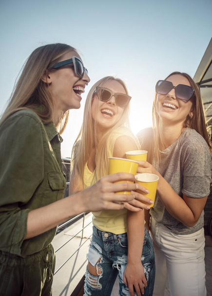 Pretty Women Drinking on a Sunny Balcony - Fotografie, Obrázek