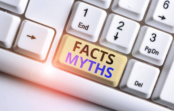 Text sign showing Facts Myths. Conceptual photo work based on imagination rather than on real life difference White pc keyboard with empty note paper above white background key copy space. - Photo, Image