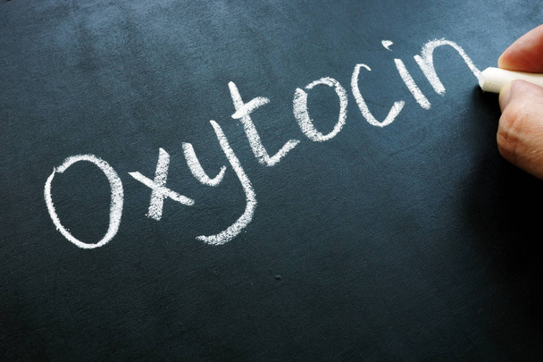 Oxytocin Oxt hormone handwritten on the blackboard. - Fotó, kép