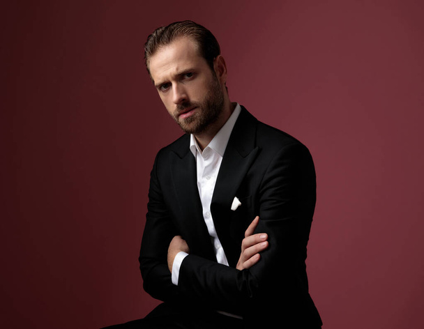 Serious elegant man frowning and holding his arms crossed - Photo, Image