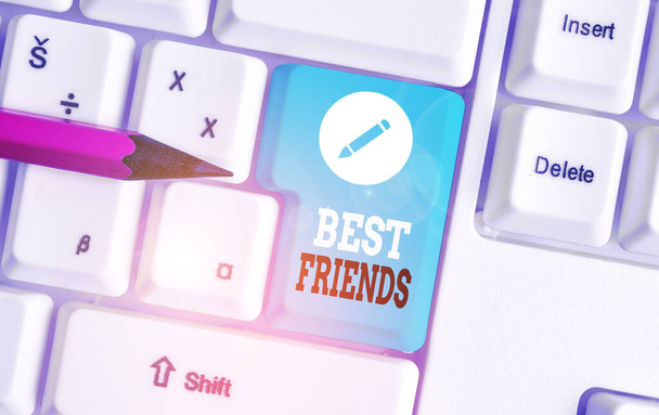 Word writing text Best Friends. Business concept for A demonstrating you value above other demonstratings Forever buddies White pc keyboard with empty note paper above white background key copy space. - Photo, Image