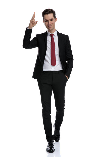 Happy businessman holding his hand in his pocket and explaining - Photo, Image