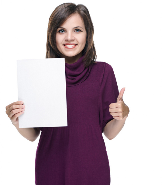 Attractive young woman in a red dress. Holds a poster and showin - Фото, изображение