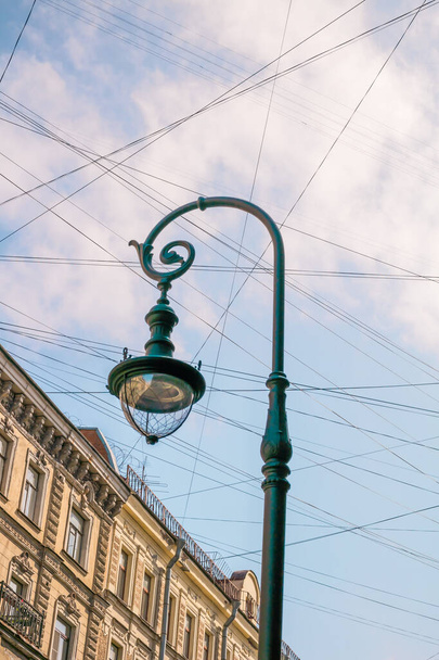 Street lamp, wires, street sign against blue sky - Фото, зображення