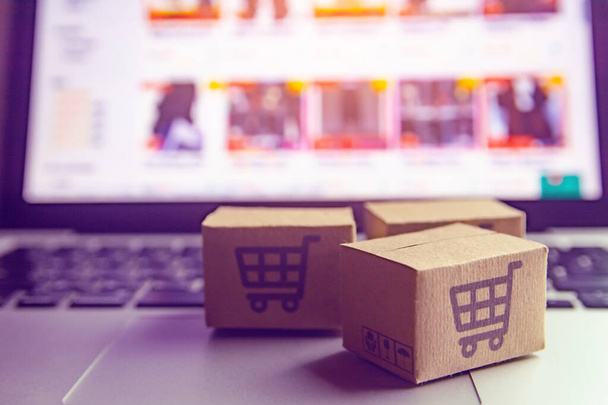 Online shopping - Paper cartons or parcel with a shopping cart l - 写真・画像