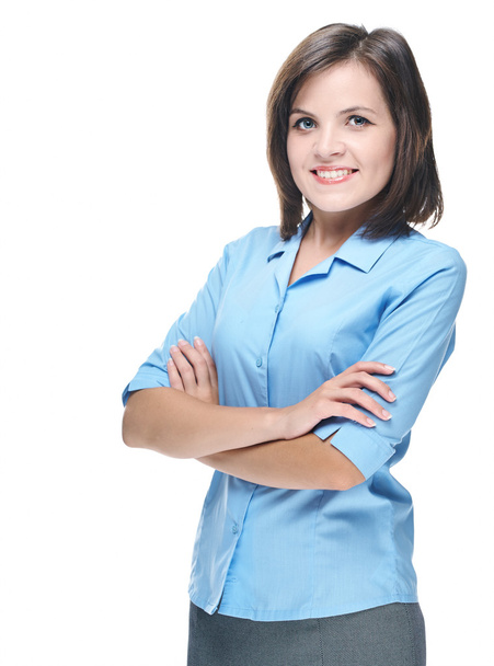 Attractive young woman in a blue blouse. Standing with folded ha - Foto, Imagen