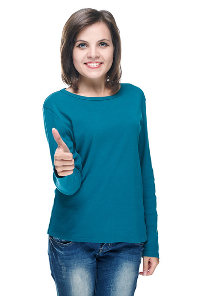 Una joven atractiva con una camisa azul. Mostrando pulgares hacia arriba
. - Foto, imagen