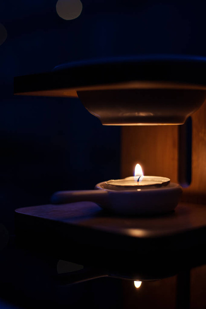 little tea candle in a bamboo burner - 写真・画像