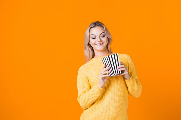 Young woman watching a movie and eating popcorn. - Photo, Image