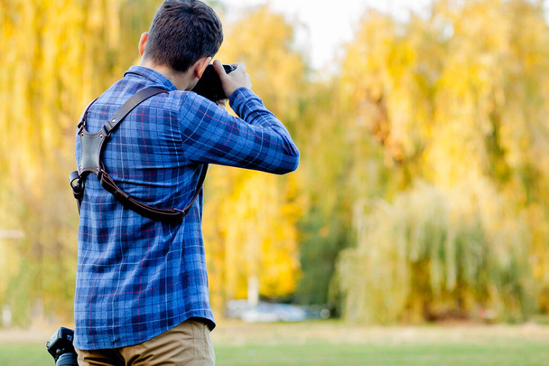 Professional photographer in action with two cameras on a shoulder straps - Photo, image
