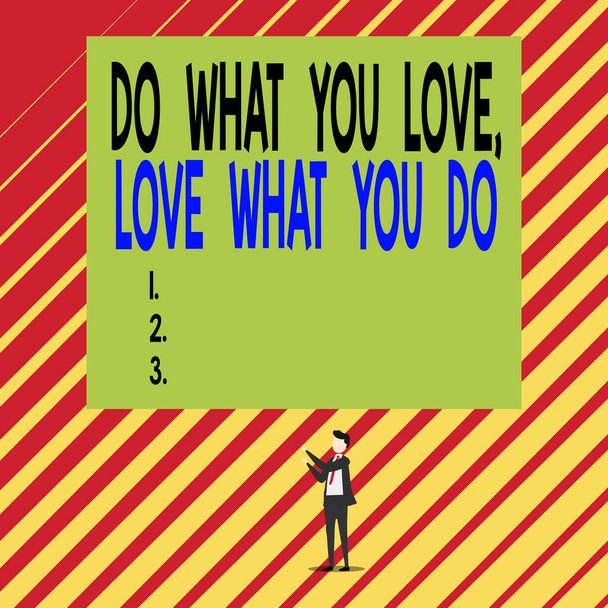 Text sign showing Do What You Love Love What You Do. Conceptual photo Pursue your dreams or passions in life Short hair immature young man stand in front of rectangle big blank board. - Photo, Image