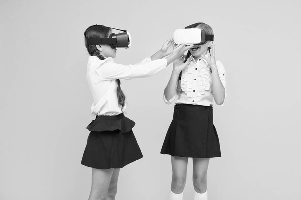 Experiences communicate and manage projects.Kids use modern VR technology. Virtual reality. VR headset. Future education. Children schoolgirls wear wireless VR glasses. Exploring augmented reality - Photo, image