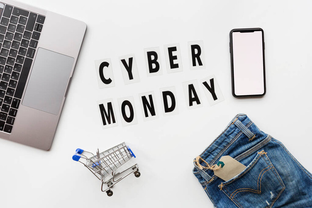 Creative promotion composition Cyber monday text and laptop on white background. Flat lay, top view, overhead, mockup, template. Minimal abstract background. Online shopping, sale, promo. Web banner - Zdjęcie, obraz