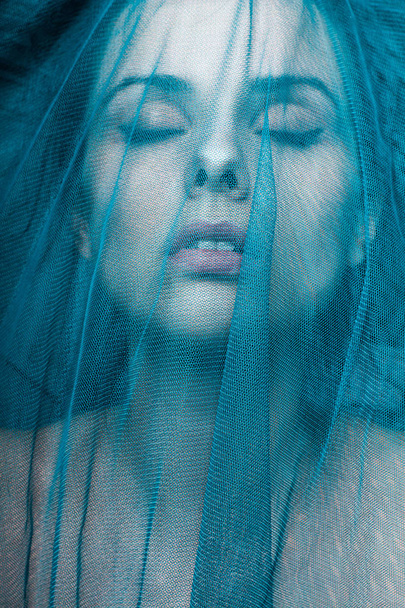 Young woman, blue color material - Foto, immagini