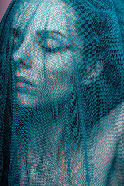 Young woman, blue color material - Foto, immagini
